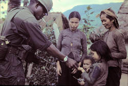 soldier with Vietnamese villagers and children